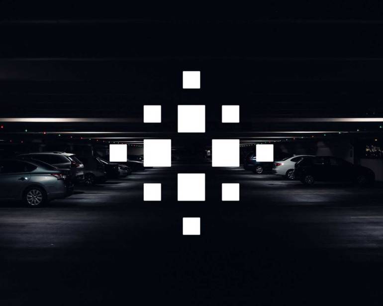 Envisics logo overlay in dark underground car park